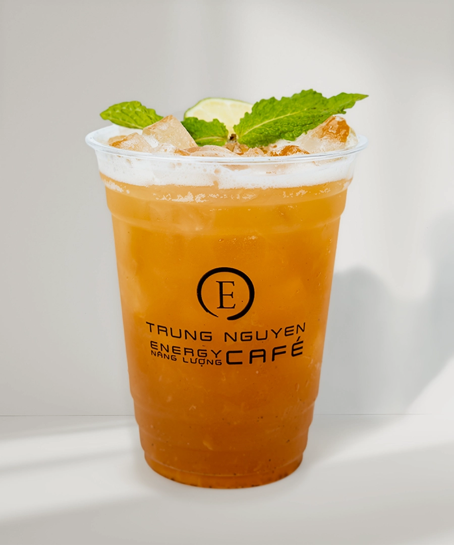 Trung Nguyen E-Coffee Energy drink with ice, garnished with mint leaves, presented in a clear